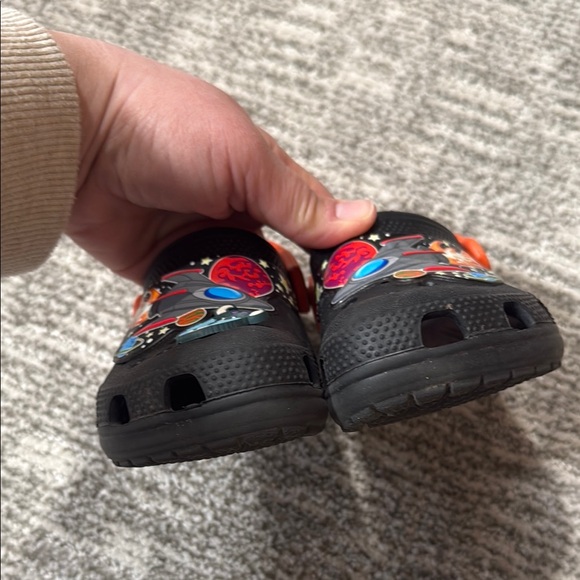 Crocs Kids' Black and Orange Space Clogs - Picture 2 of 6